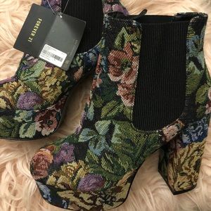 Multi-color floral slip on ankle platforms.